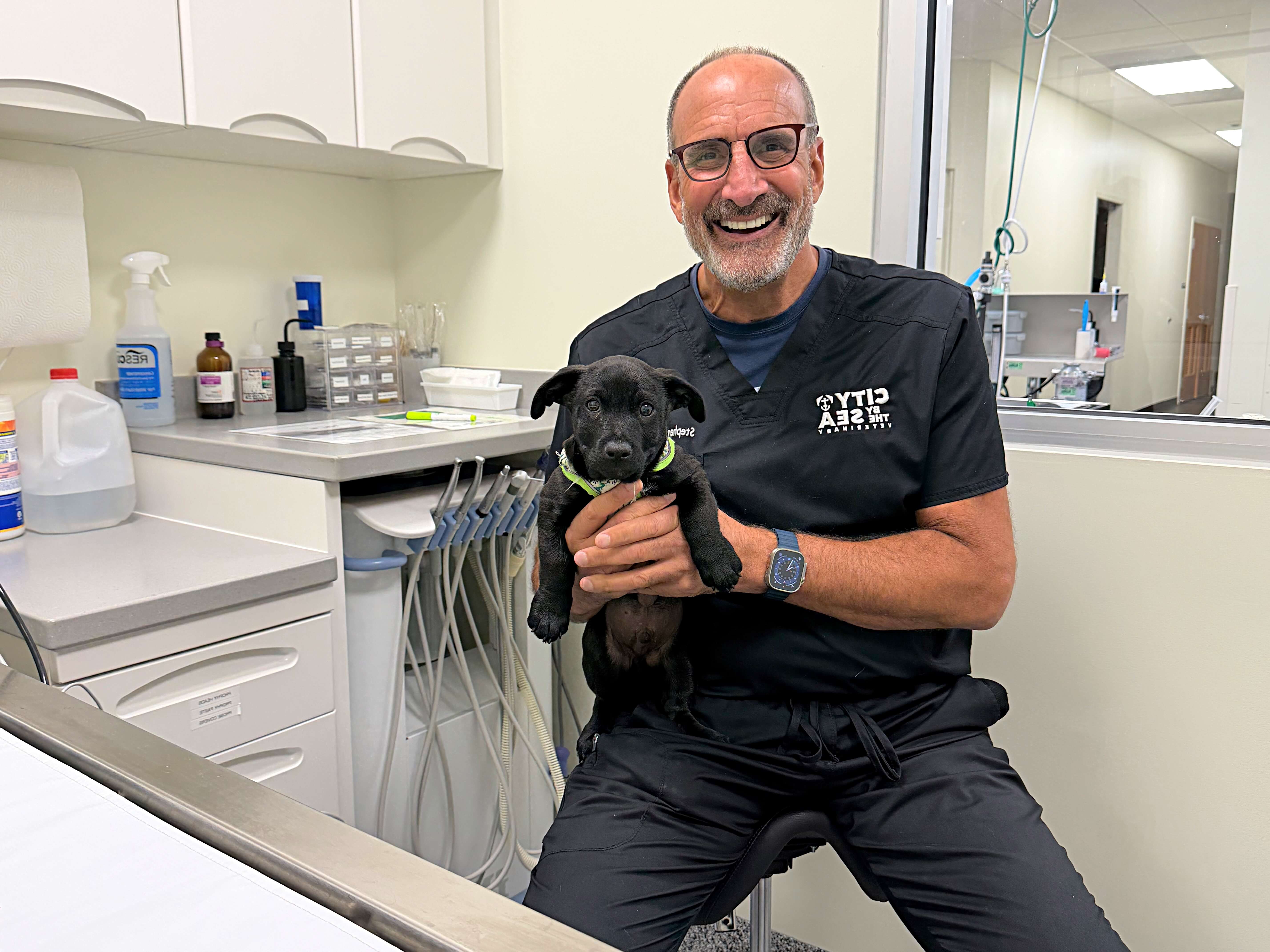 Dr. Riback holding a puppy